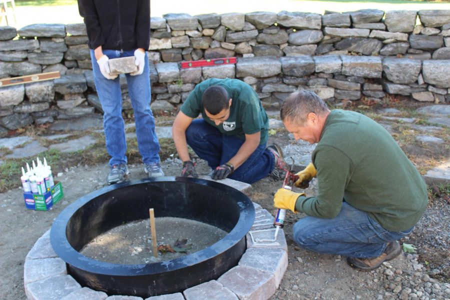 Working on his firepit at the Elk’s Club , Matt Scipioni represents the hard work and dedication necessary to be an Eagle Scout, as also embodied by fellow Eagle scout Peter Arnold.