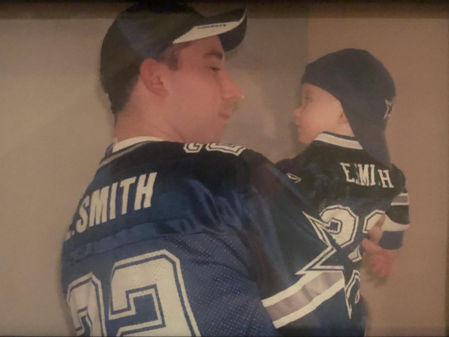 Two die-hard Dallas Cowboys fans: Baby Zach Salvo, held by his dad, David Salvo.  
