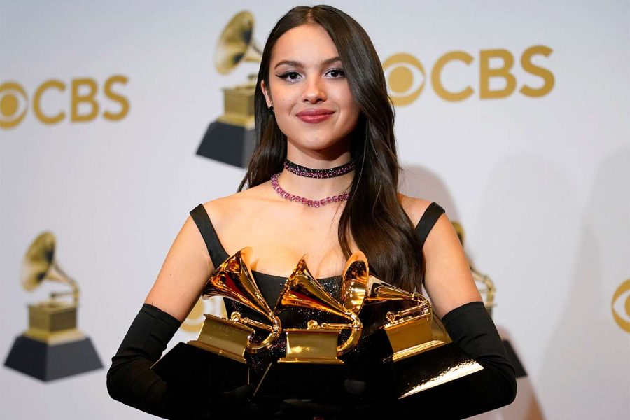 Olivia+Rodrigo%2C+at+the+64th+annual+Grammy+awards%2C+holds+up+the+three+trophies+that+she+won+for+Best+New+Artist%2C+Best+Pop+Solo+Performance%2C+and+Best+Pop+Vocal+Album.