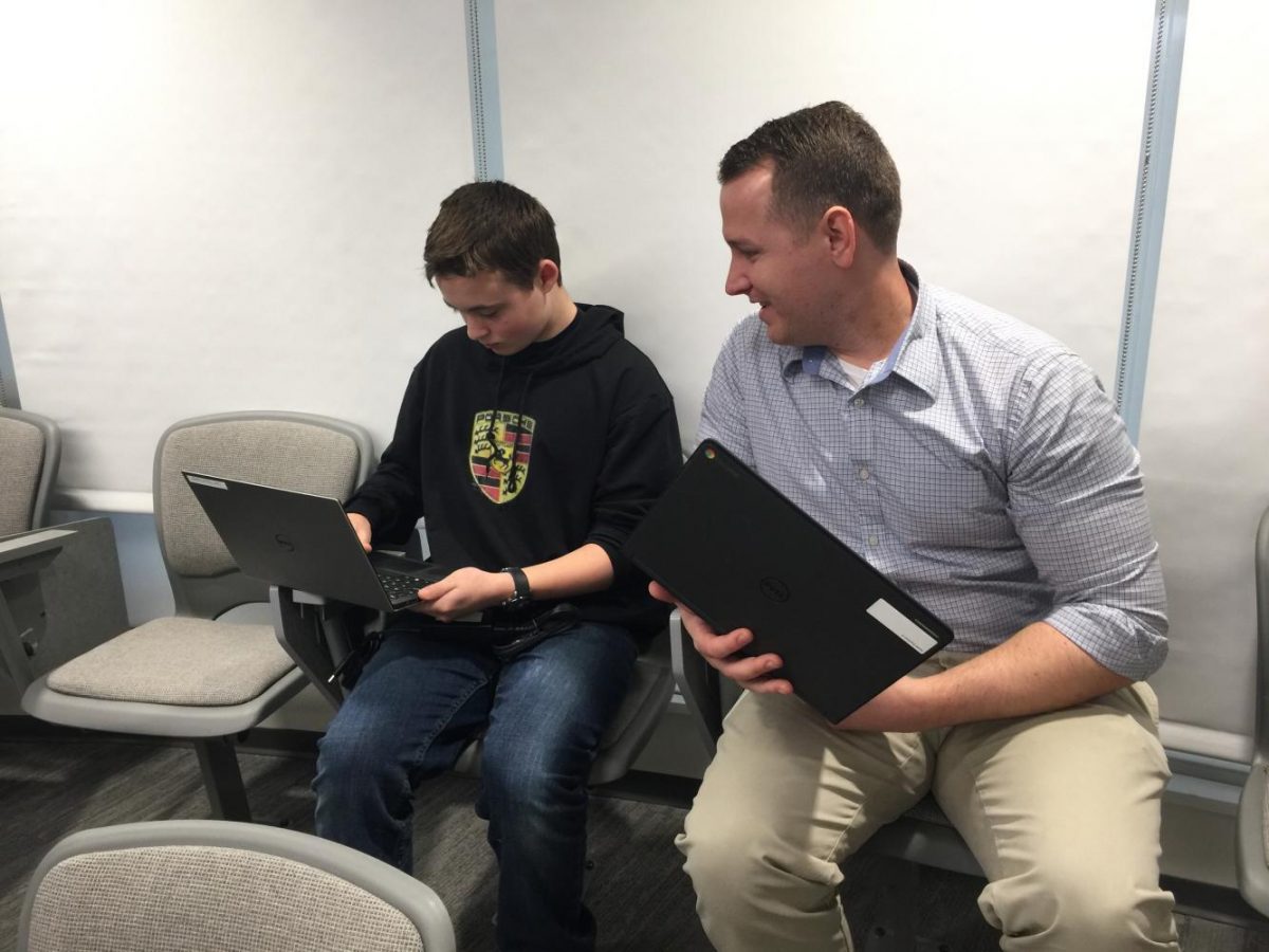 Techie John Castellano introduces a student to the inner trappings of his laptop.