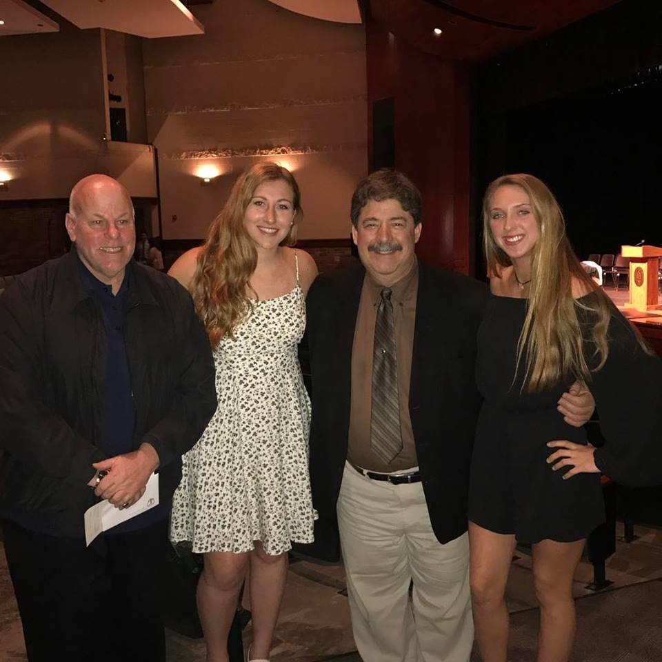 Inductee Pat Moriarity and keynote speaker Pete Goumas are heartily congratulated by NHS members Julia Borsari and 
Makayla Koehler.